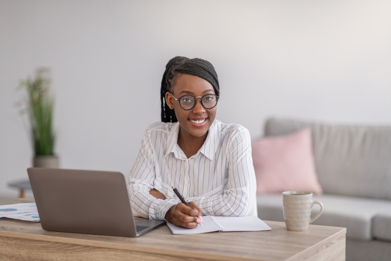 Positive,black,woman,with,stylish,glasses,manager,working,from,home