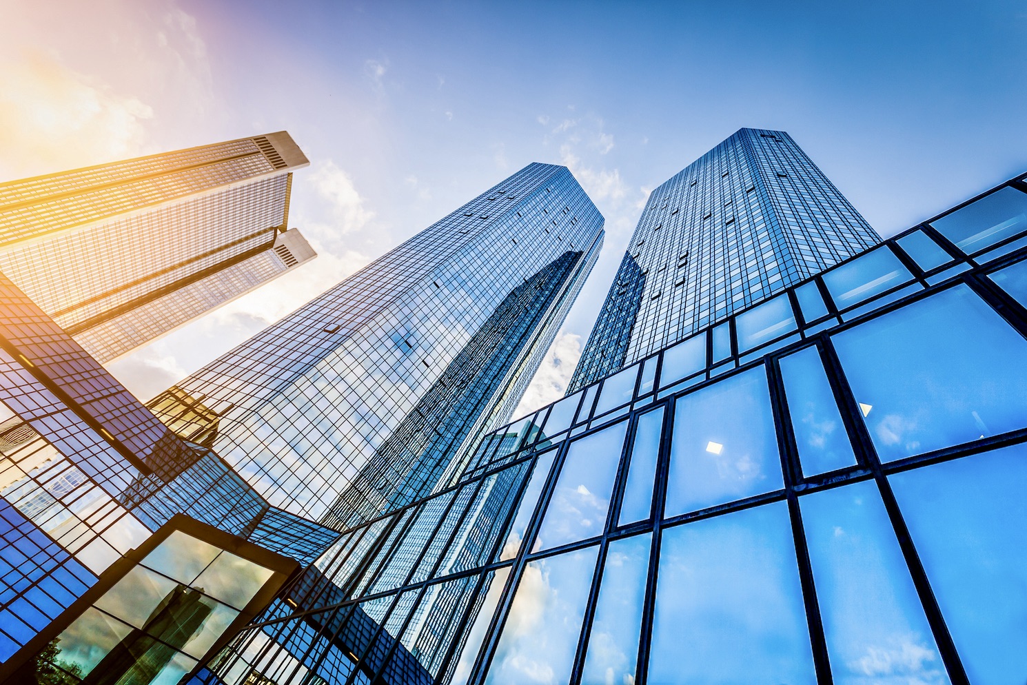 Bottom,view,of,modern,skyscrapers,in,business,district,at,sunset