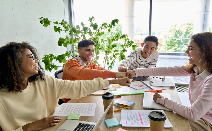 Young,happy,laughing,creative,startup,team,four,multiethnic,coworkers,diverse