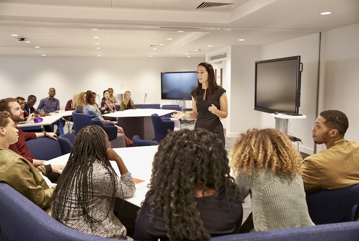 Female,teacher,addressing,university,students,in,a,classroom